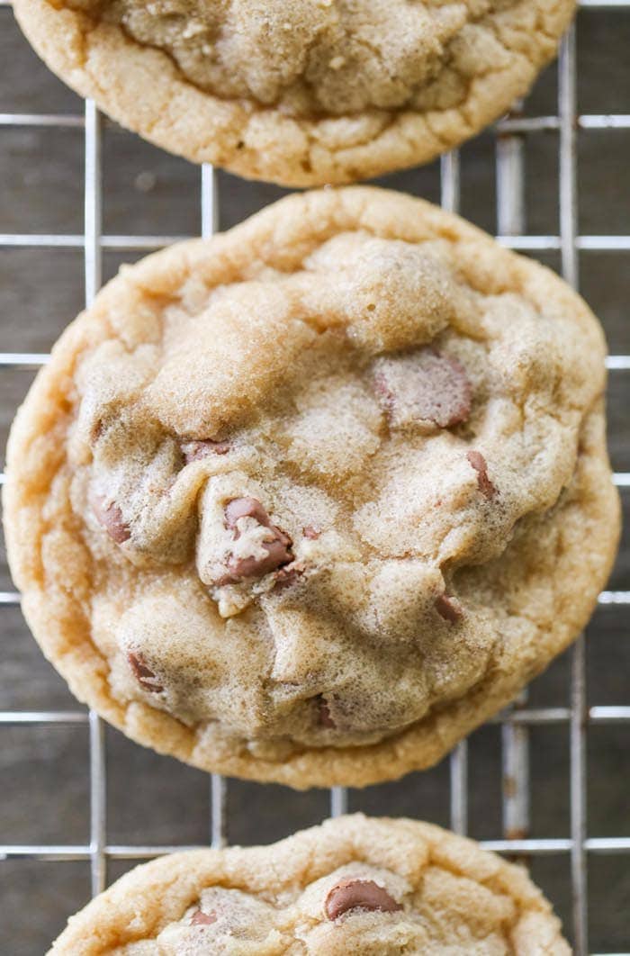 close up of a chocolate chip cookie on a cooling wrack